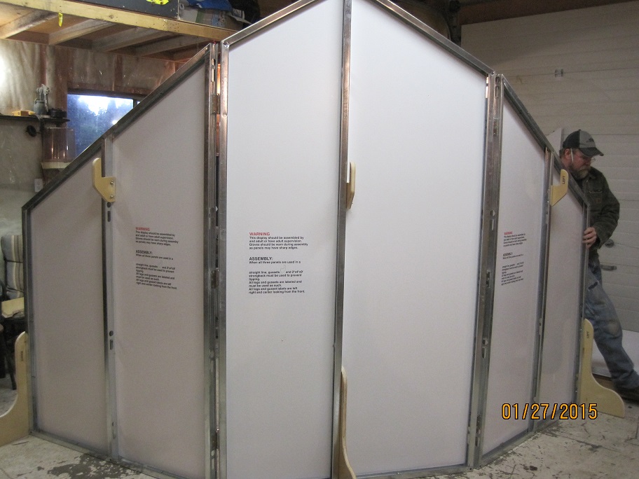 Man assembling a large portable structure